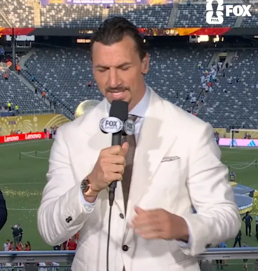 Zlatan Ibrahimović speaking into a FOX Sports microphone at a soccer stadium.