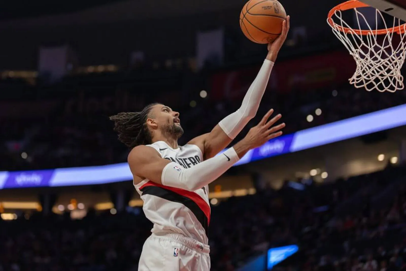 Matisse Thybulle goes up for a finger roll layup during an NBA game.